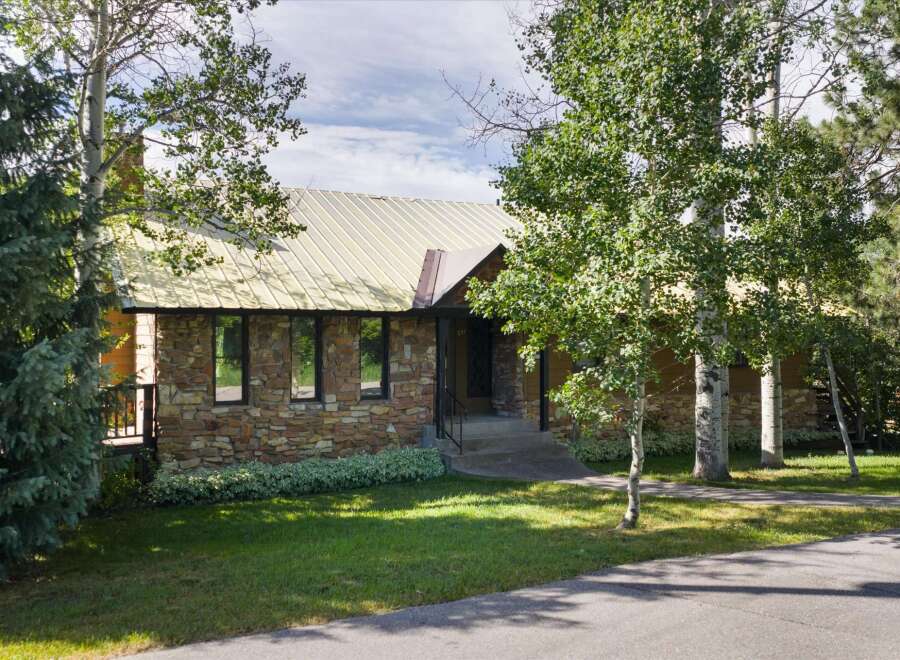 Discover this charming home featuring a unique stone facade and a durable metal roof, offering both aesthetic appeal and longevity.
