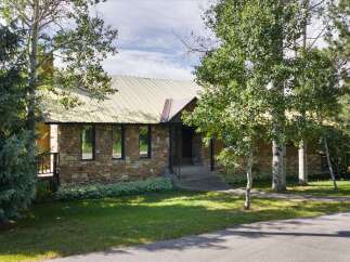 Discover this charming home featuring a unique stone facade and a durable metal roof, offering both aesthetic appeal and longevity.