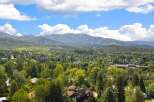Nestled amidst lush greenery and mature trees, this property offers a serene mountain retreat with stunning views of the surrounding landscape.