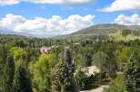 Nestled amidst lush greenery and mature trees, this property offers a serene escape with breathtaking mountain views.