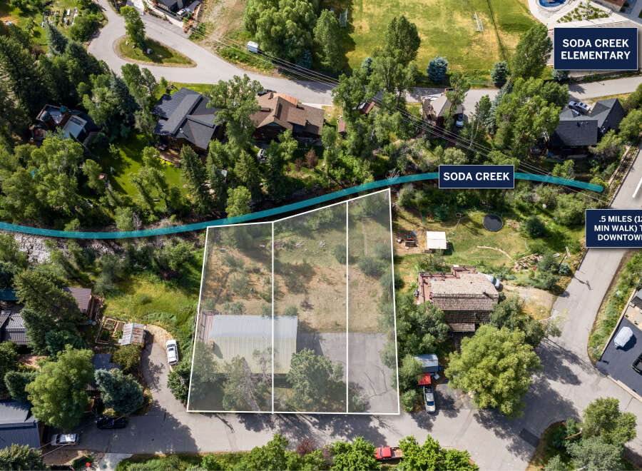 Discover prime real estate with this aerial view showcasing a property adjacent to Soda Creek, offering a serene natural setting.