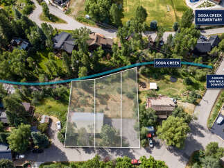 Discover prime real estate with this aerial view showcasing a property adjacent to Soda Creek, offering a serene natural setting.