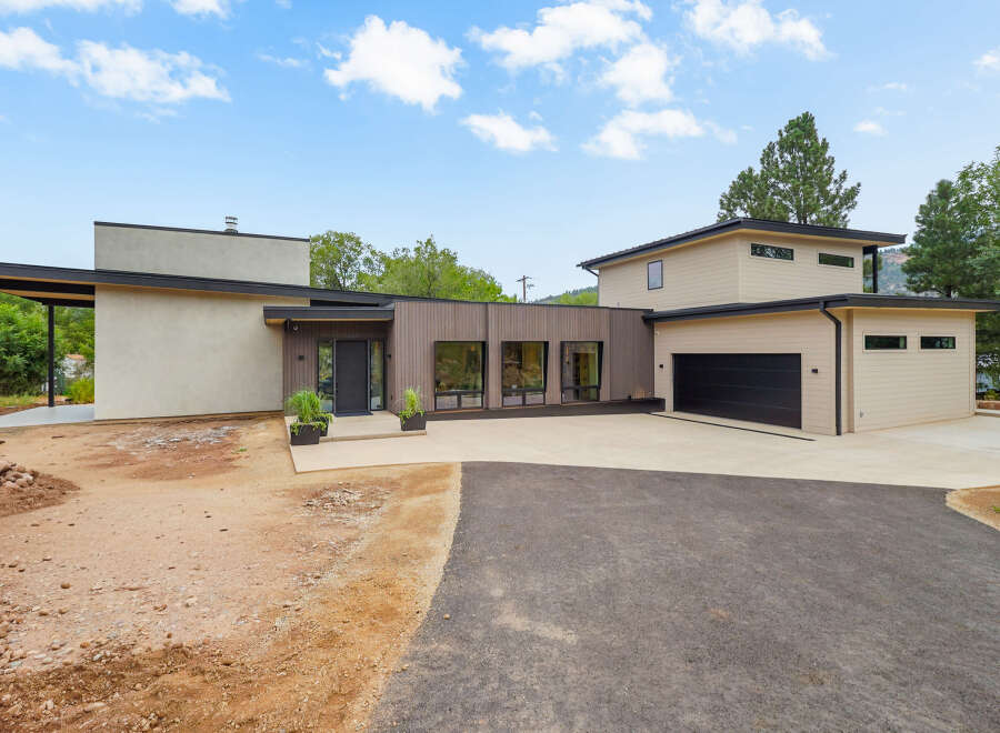 Discover modern living in this stunning new construction home, featuring a sleek design with a mix of stucco and wood siding.