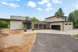 Discover modern living in this stunning new construction home, featuring a sleek design with a mix of stucco and wood siding.