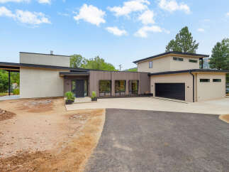 Discover modern living in this stunning new construction home, featuring a sleek design with a mix of stucco and wood siding.