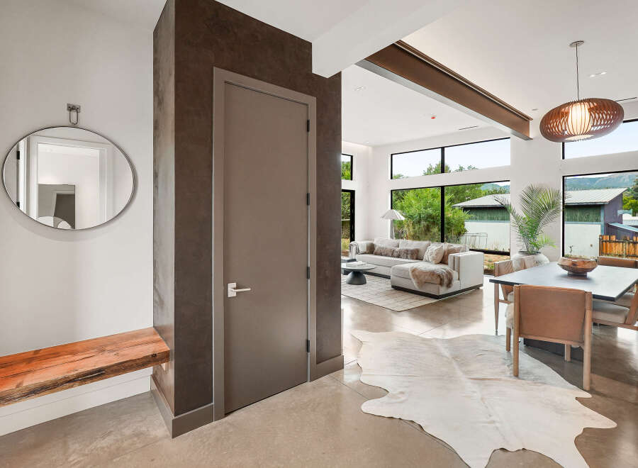 Step into modern luxury with this stunning entryway featuring a sleek, minimalist design.