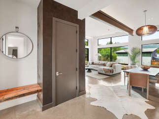Step into modern luxury with this stunning entryway featuring a sleek, minimalist design.
