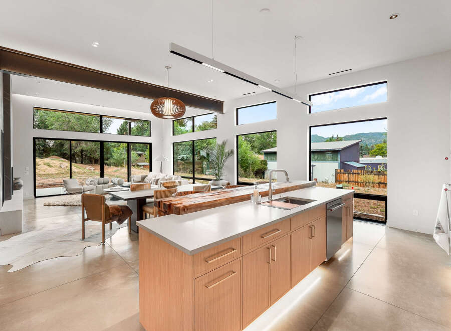 Experience modern living in this stunning open-concept home featuring a gourmet kitchen with a large island and sleek cabinetry.
