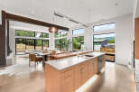 Experience modern living in this stunning open-concept home featuring a gourmet kitchen with a large island and sleek cabinetry.