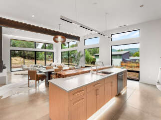 Experience modern living in this stunning open-concept home featuring a gourmet kitchen with a large island and sleek cabinetry.