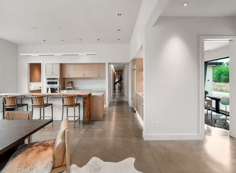 Experience modern living in this stunning open-concept home featuring a sleek kitchen with custom cabinetry and a live-edge island perfect for entertaining.