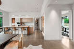 Experience modern living in this stunning open-concept home featuring a sleek kitchen with custom cabinetry and a live-edge island perfect for entertaining.