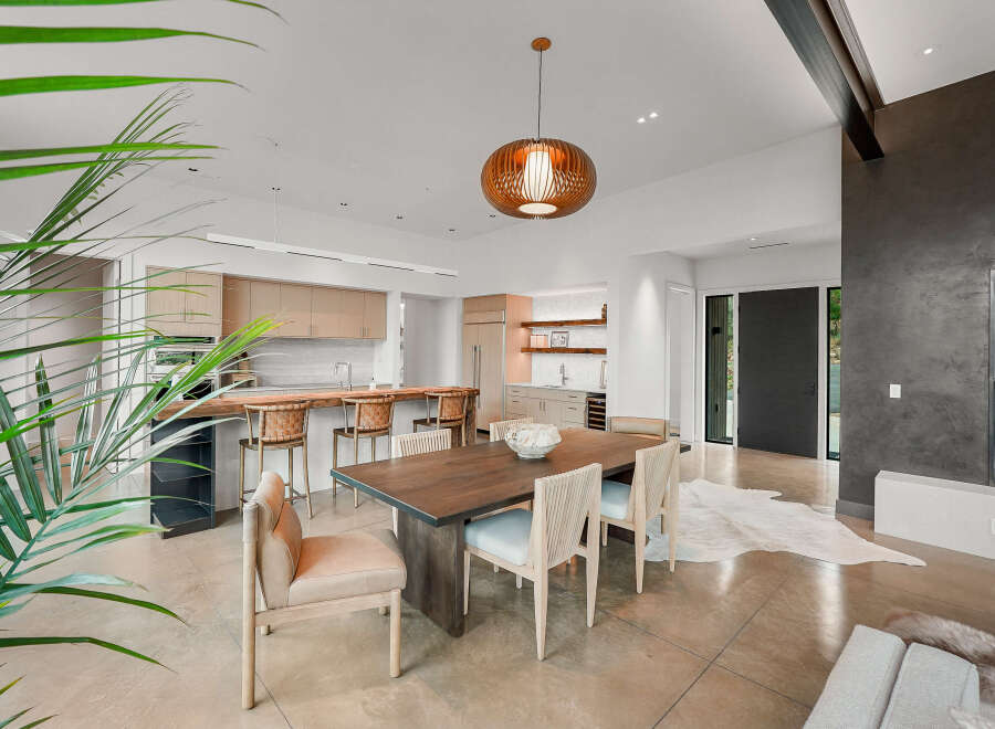Experience modern luxury in this open-concept living space, featuring a gourmet kitchen with ample cabinetry and a stunning waterfall island.