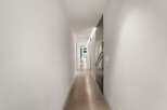 Experience modern living in this stunning hallway featuring sleek, minimalist design.