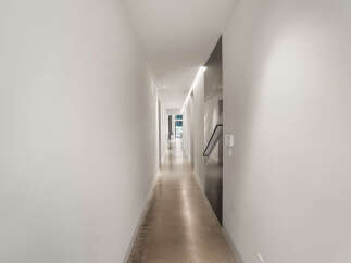 Experience modern living in this stunning hallway featuring sleek, minimalist design.