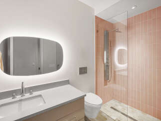 Experience modern luxury in this stunning bathroom, featuring a sleek vanity with an illuminated mirror and a spacious walk-in shower.