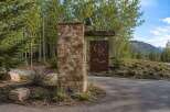 Discover the entrance to Castle Rock, a stunning property nestled amidst a serene forest landscape.