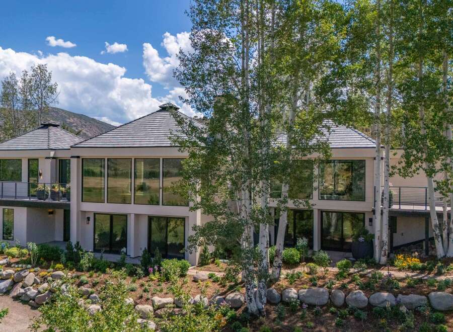 Experience luxury living in this stunning modern home, featuring expansive floor-to-ceiling windows that flood the interior with natural light and offer breathtaking views of the surrounding landscape.