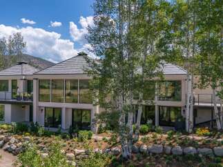Experience luxury living in this stunning modern home, featuring expansive floor-to-ceiling windows that flood the interior with natural light and offer breathtaking views of the surrounding landscape.