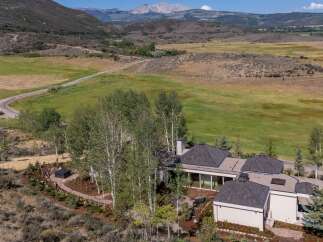 Nestled amidst rolling hills and mature aspen trees, this stunning property offers a serene mountain retreat.