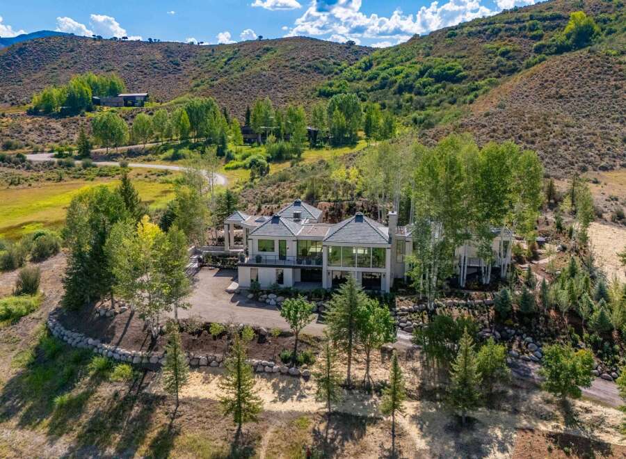 Experience luxury mountain living in this stunning contemporary estate, nestled amidst rolling hills and mature trees.