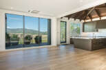 Experience breathtaking mountain views from this stunning modern living space, featuring expansive floor-to-ceiling windows that flood the interior with natural light.