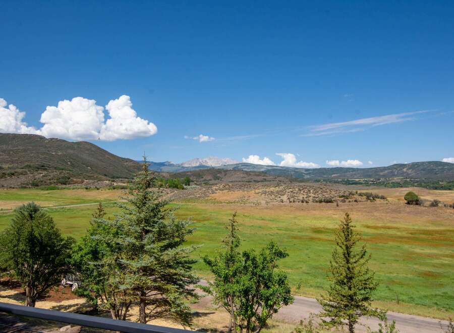 Experience breathtaking panoramic views of rolling hills and distant mountains from this stunning property.