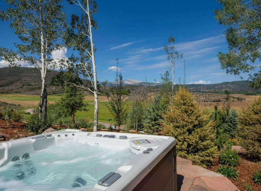 Experience ultimate relaxation with this luxurious hot tub, offering stunning panoramic views of the surrounding natural landscape.