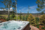 Experience ultimate relaxation with this luxurious hot tub, offering stunning panoramic views of the surrounding natural landscape.