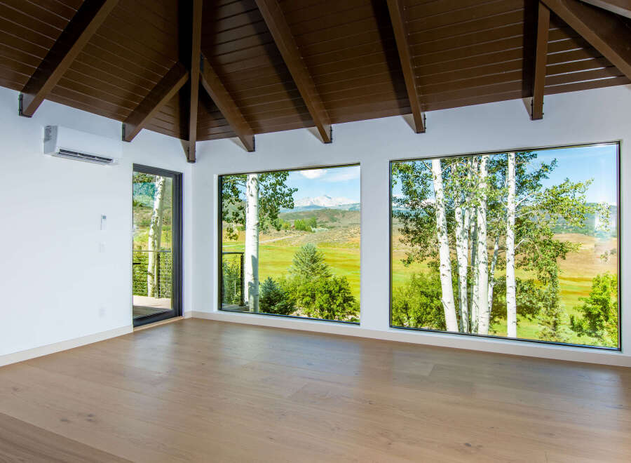 Experience breathtaking mountain views from this stunning room, featuring expansive windows that frame the picturesque landscape.