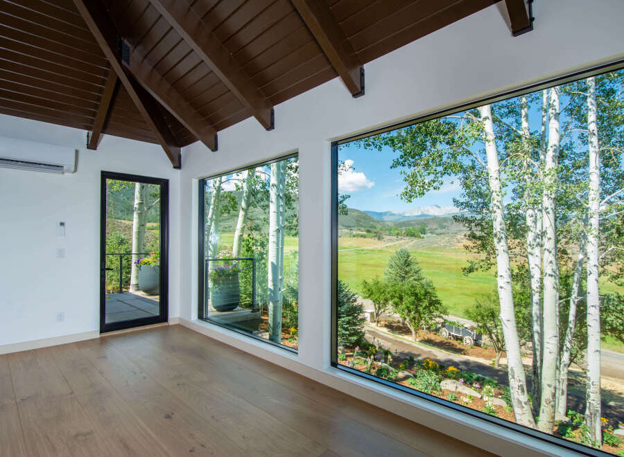 Experience breathtaking mountain views from this stunning property, featuring expansive windows that bring the outdoors in.