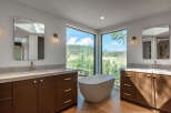 Experience luxury in this stunning bathroom featuring a freestanding bathtub with breathtaking mountain views.