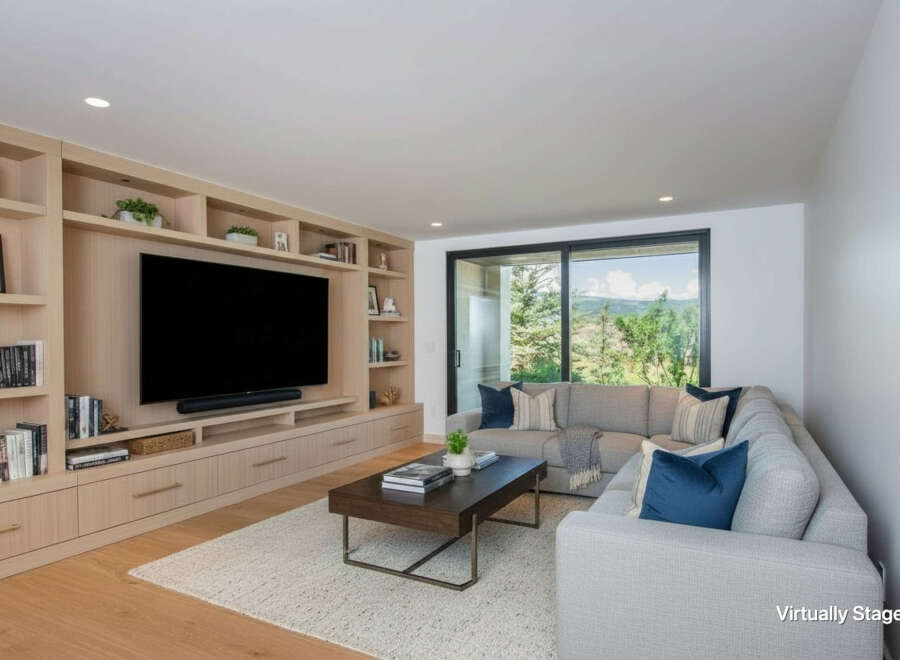 Experience modern living in this spacious living room, featuring a custom built-in entertainment center with ample storage and display shelves.