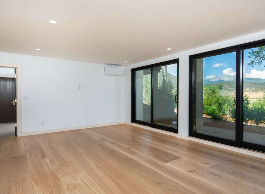 Experience breathtaking mountain views from this spacious room, featuring expansive sliding glass doors that seamlessly blend indoor and outdoor living.