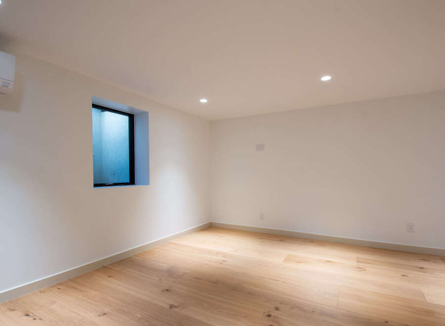 Discover modern living in this beautifully appointed room, featuring a sleek Mitsubishi air conditioning unit for optimal comfort.