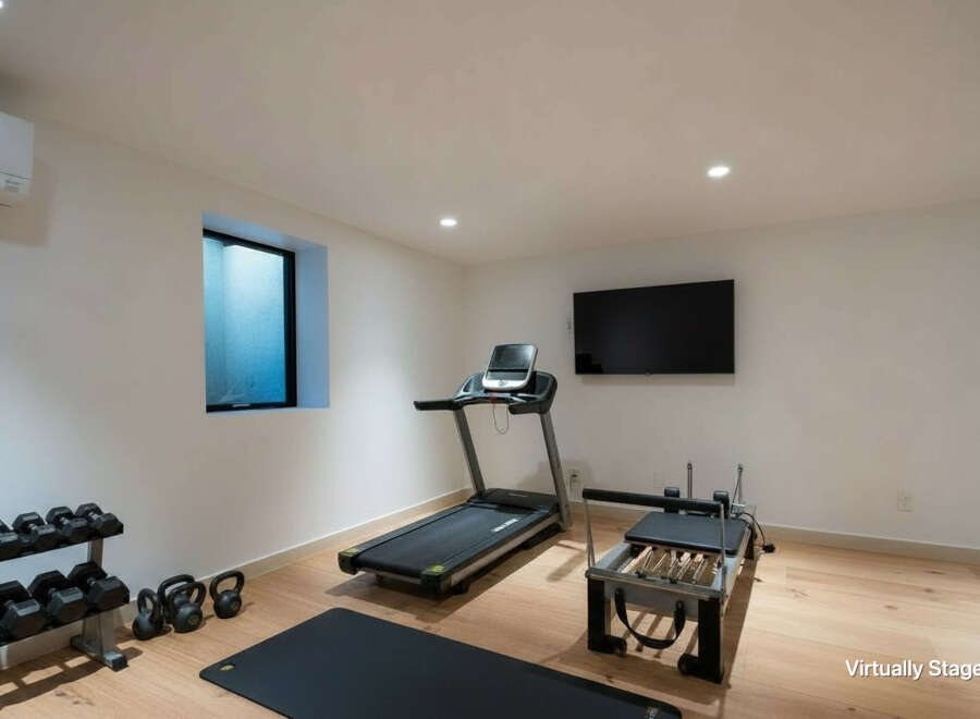 Elevate your fitness routine in this dedicated home gym, featuring a treadmill, pilates reformer, and a full set of dumbbells and kettlebells.