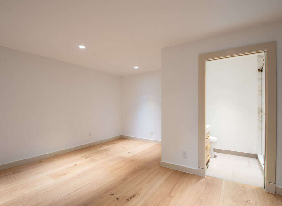 Step into this bright and airy space featuring gleaming hardwood floors and recessed lighting.