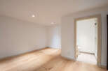Step into this bright and airy space featuring gleaming hardwood floors and recessed lighting.