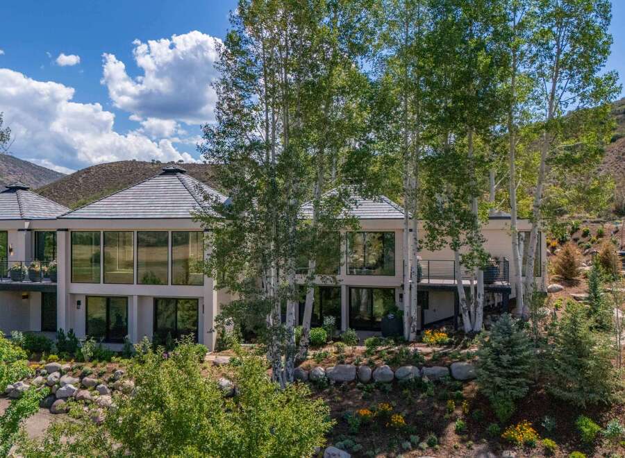 Experience luxury mountain living in this stunning contemporary home, featuring expansive windows that capture breathtaking natural light and scenic views.