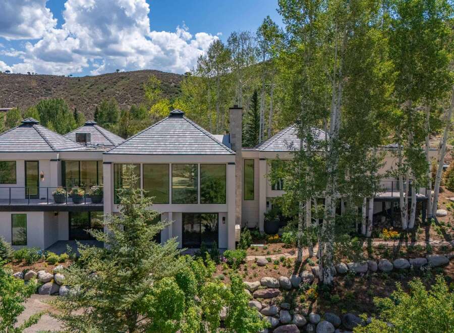 Experience luxury living in this stunning modern home, nestled amidst a picturesque mountain landscape.