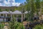 Experience luxury living in this stunning modern home, nestled amidst a picturesque mountain landscape.