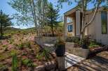 Experience luxury mountain living with this stunning home featuring a modern facade and natural stone accents.