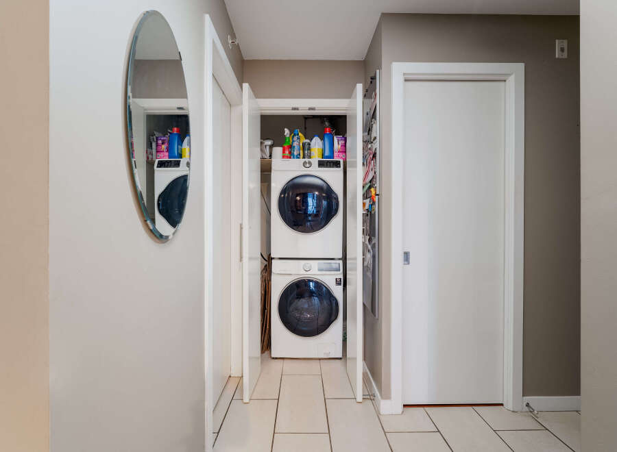 Discover the convenience of in-unit laundry with this stacked Samsung washer and dryer set, neatly tucked away in a dedicated closet.