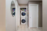 Discover the convenience of in-unit laundry with this stacked Samsung washer and dryer set, neatly tucked away in a dedicated closet.