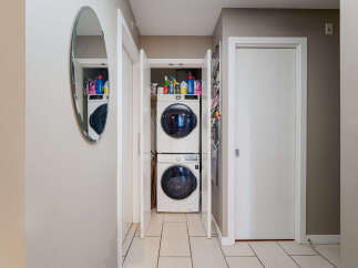 Discover the convenience of in-unit laundry with this stacked Samsung washer and dryer set, neatly tucked away in a dedicated closet.