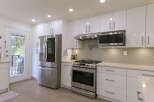 Experience modern living in this stunning kitchen featuring sleek white cabinetry and stainless steel appliances.
