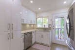 Discover this modern kitchen featuring sleek white cabinetry and a stylish subway tile backsplash.