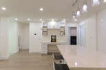 Discover modern living in this spacious open-concept home, featuring a sleek kitchen island perfect for entertaining.