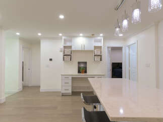 Discover modern living in this spacious open-concept home, featuring a sleek kitchen island perfect for entertaining.
