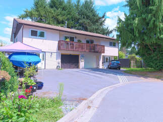 Discover this charming property featuring a spacious driveway leading to a double garage and an additional single garage.